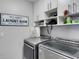 Functional laundry room with modern washer and dryer and ample storage space at 7929 Ashley Pointe Dr, Lakeland, FL 33810