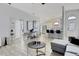 Open-concept living space with sightlines to the kitchen, wood-look flooring and modern decor at 7929 Ashley Pointe Dr, Lakeland, FL 33810