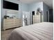 Bright main bedroom has a serene ambiance and a large dresser, creating a relaxing retreat at 7929 Ashley Pointe Dr, Lakeland, FL 33810