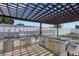 Outdoor kitchen under a pergola with a grill and counter at 7929 Ashley Pointe Dr, Lakeland, FL 33810