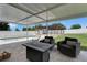 Patio featuring a seating area and fire pit, overlooking the pool at 7929 Ashley Pointe Dr, Lakeland, FL 33810