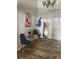 Cozy sitting area with wood-look tile flooring, modern decor and bright lighting at 7929 Ashley Pointe Dr, Lakeland, FL 33810