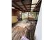 Rustic back porch with wooden flooring, covered ceiling, and view of the backyard with a pool at 803 26Th Nw St, Winter Haven, FL 33881