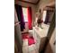 Bathroom featuring a sink with drawers, pink rug, and window with colorful curtains at 803 26Th Nw St, Winter Haven, FL 33881