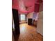 Bedroom featuring a pink ceiling, hardwood floors, and window at 803 26Th Nw St, Winter Haven, FL 33881