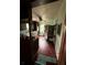 Narrow kitchen featuring a stainless steel refrigerator, lots of cabinets, and hardwood floors at 803 26Th Nw St, Winter Haven, FL 33881