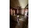 Living room featuring wood paneling, a fireplace, ceiling fan, and hardwood floors at 803 26Th Nw St, Winter Haven, FL 33881