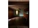 Empty living room with hardwood floors, wood paneling, and ceiling fan at 803 26Th Nw St, Winter Haven, FL 33881