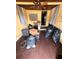 Sunroom with hardwood floors and ceiling fan in need of cleaning at 803 26Th Nw St, Winter Haven, FL 33881