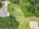Aerial view of a home with a well-maintained yard and surrounding greenery at 8640 Firestone Cir, Clermont, FL 34711