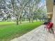 View of the backyard showing the patio area with furniture and well-maintained lawn at 8640 Firestone Cir, Clermont, FL 34711