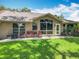 Lovely backyard with a patio, seating, and a lush green lawn on a sunny day at 8640 Firestone Cir, Clermont, FL 34711