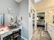 Neutral bathroom with vanity and mirror next to view into the bedroom at 8640 Firestone Cir, Clermont, FL 34711