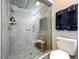 Modern bathroom featuring a glass enclosed shower with gray tiling and a rainfall shower head at 8640 Firestone Cir, Clermont, FL 34711