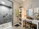 Shower with glass doors and a bathroom vanity with decor in the bathroom at 8640 Firestone Cir, Clermont, FL 34711