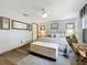 Bright bedroom features a ceiling fan, a padded storage bench, and neutral decor at 8640 Firestone Cir, Clermont, FL 34711