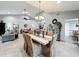 Open floor plan with dining room and living room with vaulted ceilings and skylight at 8640 Firestone Cir, Clermont, FL 34711