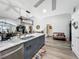 Open concept kitchen island with bar seating, stylish lighting, and stainless steel appliances at 8640 Firestone Cir, Clermont, FL 34711