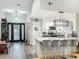 Kitchen island with bar stools adjacent to a modern kitchen with stainless steel appliances at 8640 Firestone Cir, Clermont, FL 34711