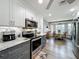 Renovated kitchen featuring stone countertops, stainless appliances, and a cozy breakfast nook at 8640 Firestone Cir, Clermont, FL 34711