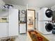 Convenient laundry area in the garage with stacked washer and dryer units at 8640 Firestone Cir, Clermont, FL 34711