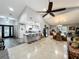 Spacious open-concept living area with vaulted ceilings, a fan, and a seamless flow to the kitchen at 8640 Firestone Cir, Clermont, FL 34711