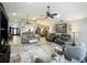 Open-concept living area with neutral walls, ceiling fans, and a stylish area rug at 8640 Firestone Cir, Clermont, FL 34711