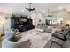 Spacious living room features a large entertainment center, neutral furnishings, and two ceiling fans at 8640 Firestone Cir, Clermont, FL 34711
