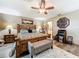 Well-furnished bedroom with a wooden bed frame, a bench, and bedside tables with lamps at 8640 Firestone Cir, Clermont, FL 34711