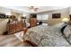 Inviting bedroom featuring wood furniture, a comfortable bed, and a ceiling fan at 8640 Firestone Cir, Clermont, FL 34711
