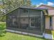 Enclosed screened porch featuring comfortable seating, perfect for relaxing outdoors at 8640 Firestone Cir, Clermont, FL 34711