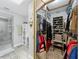 Spacious walk-in closet with custom shelving, hanging rods, and a mirrored sliding door at 8640 Firestone Cir, Clermont, FL 34711