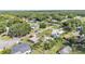 Aerial shot of the home nestled among lush greenery and mature trees in a neighborhood setting at 1019 Milner E Dr, Lakeland, FL 33810