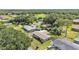 Wide aerial perspective showcases the home’s position with a fenced yard, greenery, and neighborhood setting at 1019 Milner E Dr, Lakeland, FL 33810