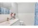 Well-lit bathroom featuring a sink, a toilet, a shower, and ample storage space for toiletries at 1019 Milner E Dr, Lakeland, FL 33810