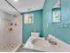 Bright bathroom featuring a shower, toilet, window, and well-lit vanity with a sink at 1019 Milner E Dr, Lakeland, FL 33810