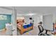 Spacious bedroom featuring hardwood floors, a large window, and convenient access to an en-suite bathroom at 1019 Milner E Dr, Lakeland, FL 33810
