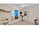 Bedroom showcasing tile floors, a ceiling fan, and window with decorative curtain and unique decor at 1019 Milner E Dr, Lakeland, FL 33810