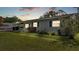 Well-maintained single-story home showcasing lush green lawn, brick facade and manicured landscaping at 1019 Milner E Dr, Lakeland, FL 33810