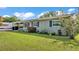 Charming home featuring a brick exterior, well-manicured lawn, and lush landscaping at 1019 Milner E Dr, Lakeland, FL 33810