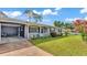 Charming single story home with brick accents, carport, well-maintained lawn, and inviting curb appeal at 1019 Milner E Dr, Lakeland, FL 33810