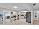 Open-concept kitchen features light blue cabinetry, a black refrigerator, and seamless flow to living area at 1019 Milner E Dr, Lakeland, FL 33810
