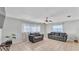 Bright living room with tile floors, ceiling fan, and two gray sofas at 1019 Milner E Dr, Lakeland, FL 33810