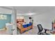 Bedroom with wood-look flooring and door leading to bathroom at 1019 Milner E Dr, Lakeland, FL 33810