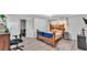 Bedroom with wood-look flooring and door leading to bathroom at 1019 Milner E Dr, Lakeland, FL 33810