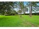 Expansive backyard featuring lush greenery, mature trees, and a well-maintained lawn at 105 Woden Way, Winter Haven, FL 33884