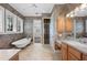 Bright bathroom features a soaking tub, vanity, and tiled floor at 105 Woden Way, Winter Haven, FL 33884