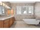 Bathroom featuring a soaking tub with a window view and a vanity at 105 Woden Way, Winter Haven, FL 33884