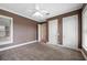 Spacious bedroom featuring carpet flooring, a ceiling fan, and multiple windows at 105 Woden Way, Winter Haven, FL 33884