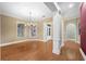 Dining room with hardwood floors, a chandelier, large windows, and white trim at 105 Woden Way, Winter Haven, FL 33884